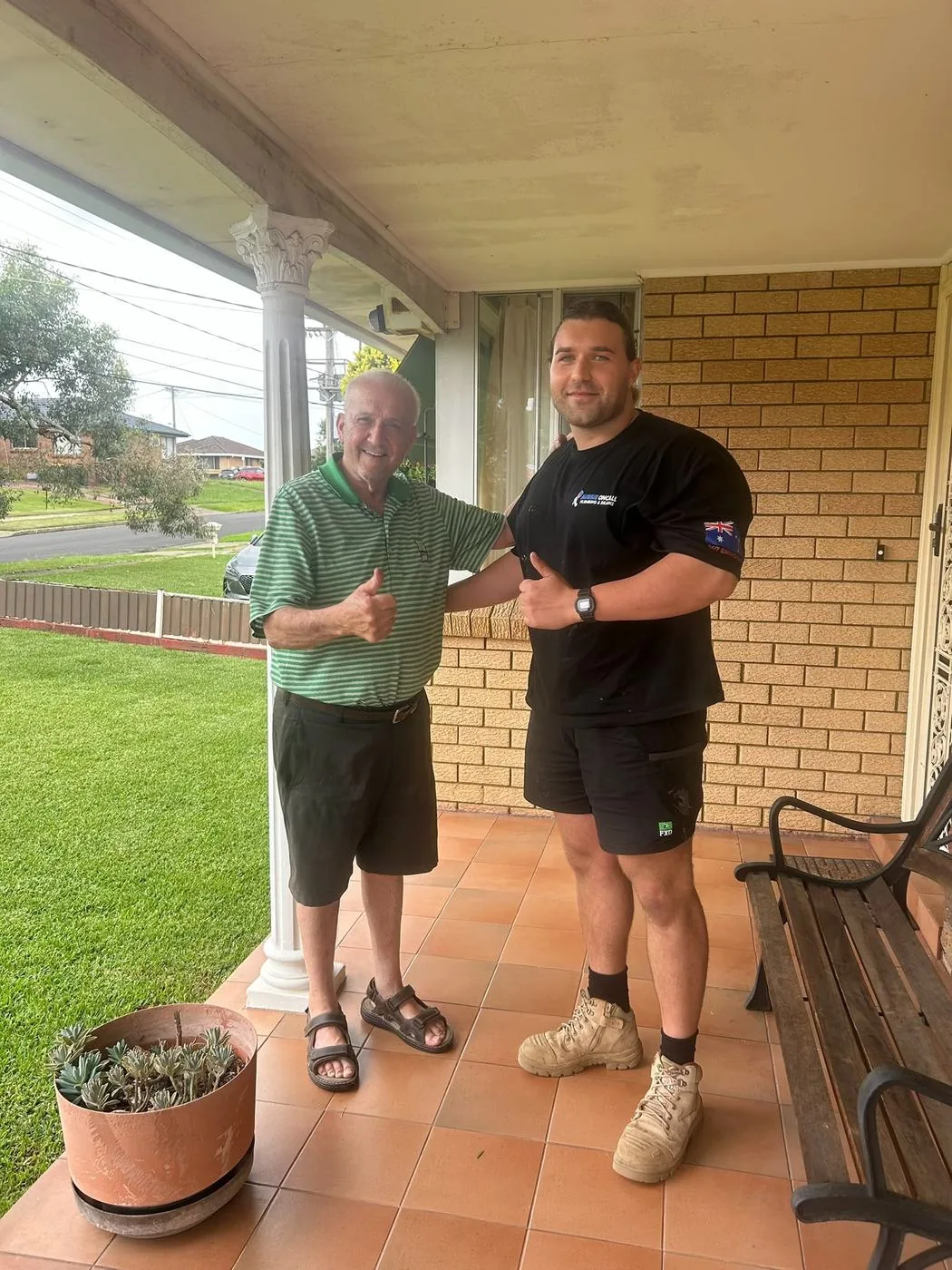 Plumber with a customer on their front verandah