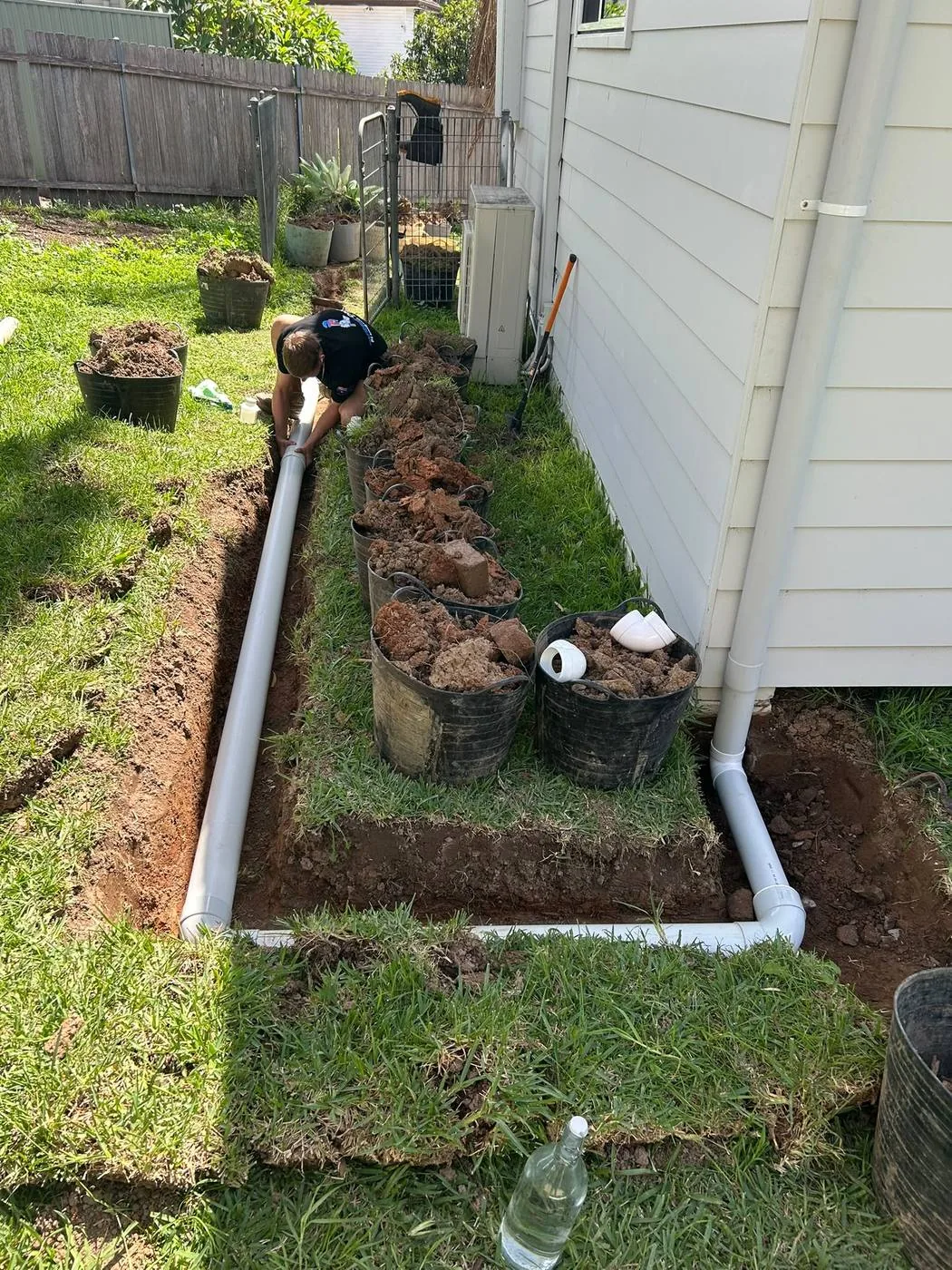 Stormwater drainage pipe laid beside a house