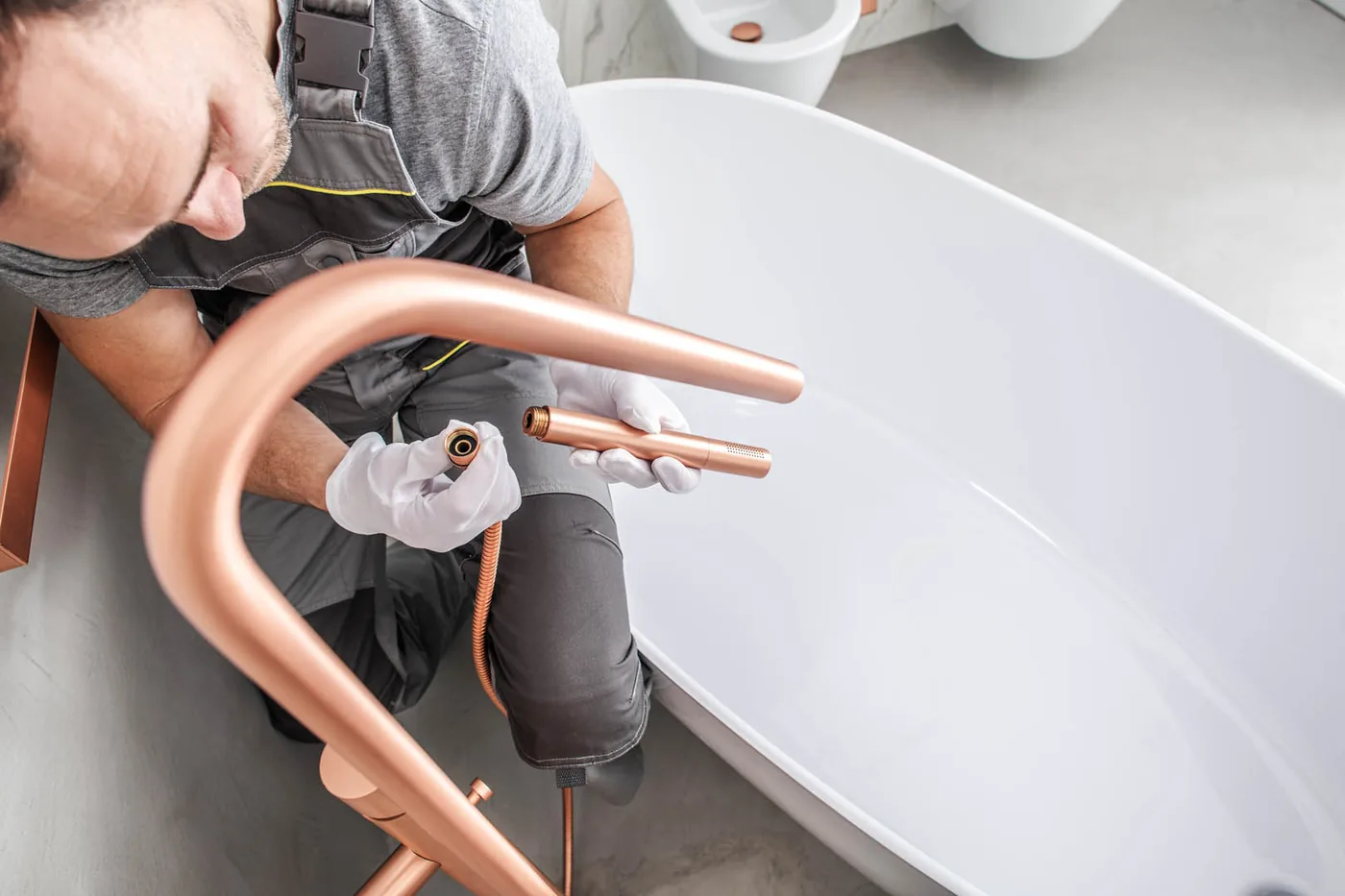 Plumber connecting the waste on a new bathtub