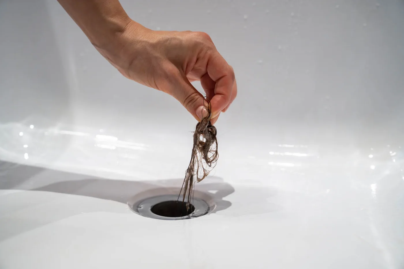 Hair pulled from a blocked basin drain