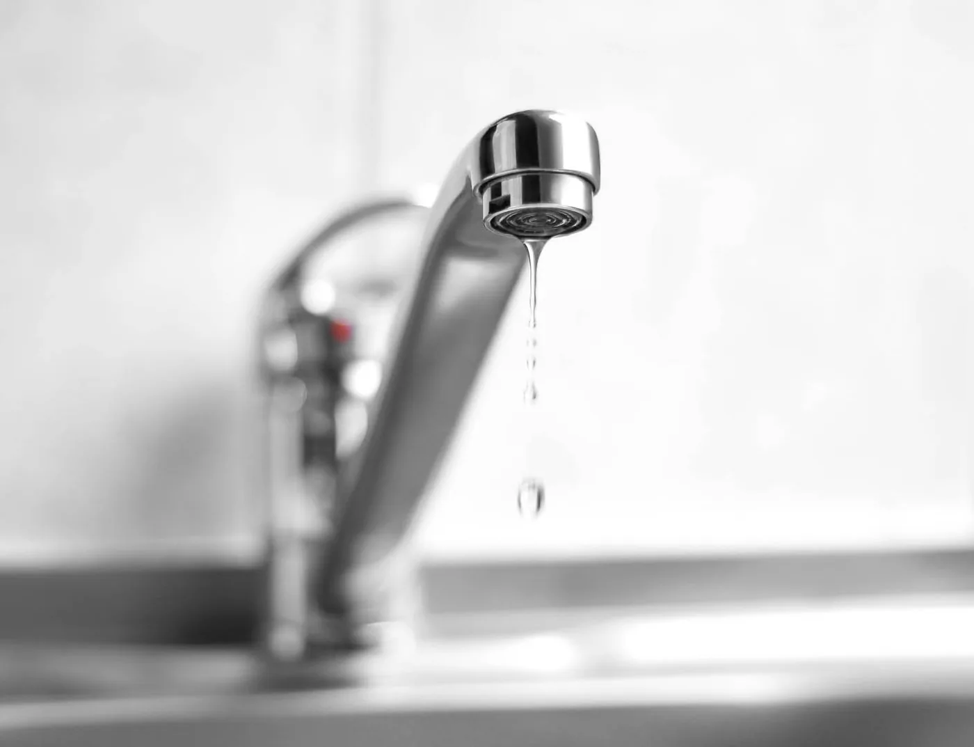 A kitchen tap dripping from a worn washer