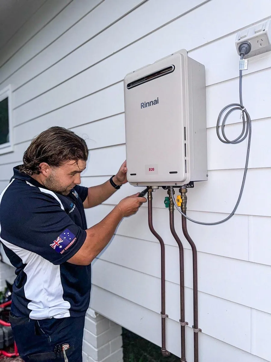 Plumber connecting a continuous-flow hot water unit