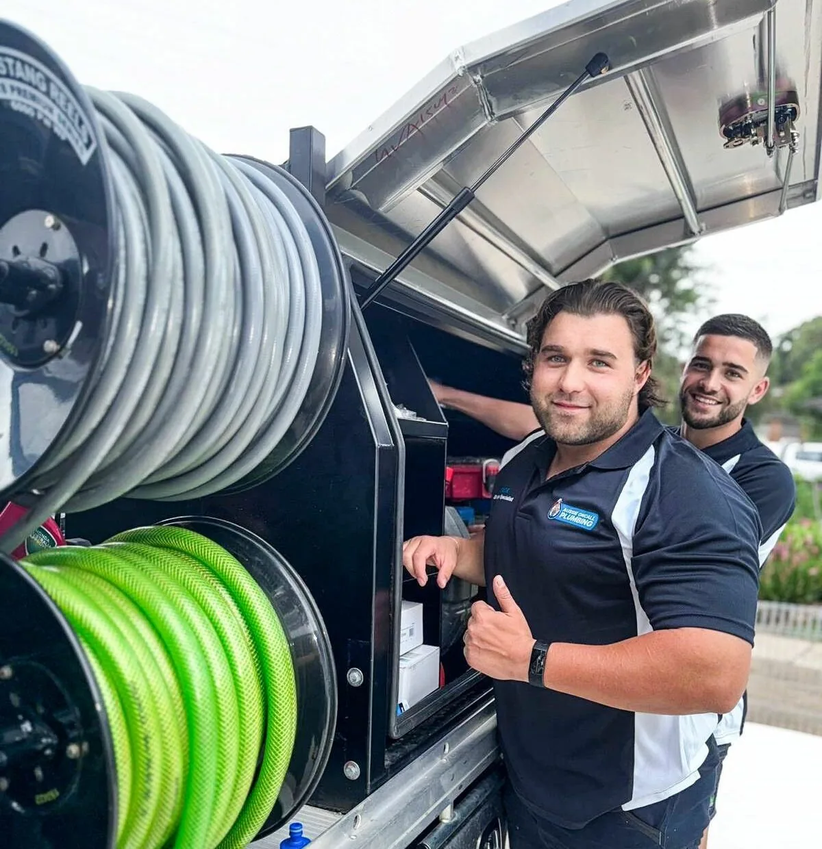 Two of the team at the van with the jetting reels